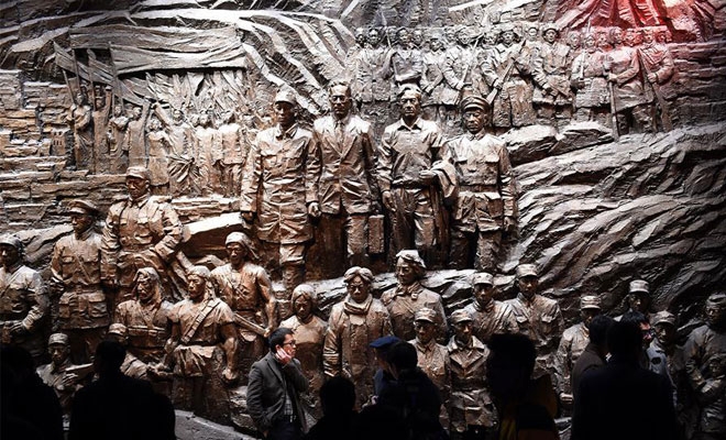 People visit the new section of the Memorial Hall of the Victims in Nanjing Massacre in Nanjing, capital of east China's Jiangsu Province, Dec. 7, 2015. The new hall opened on Monday, featuring 1,100 photos and 6,000 items of relics. (Xinhua/Han Yuqing)