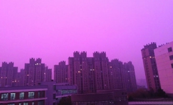 Nanjing city, the capital of Jiangsu Province, is covered in a blanket of red-hued smog on Tuesday.